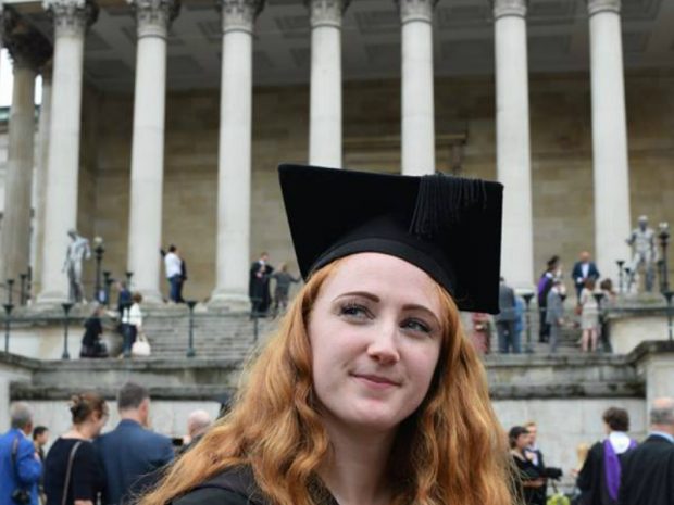 Mirium with graduation hat in front of a building