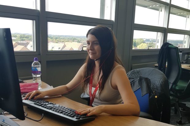 Holly sitting at her desk working.