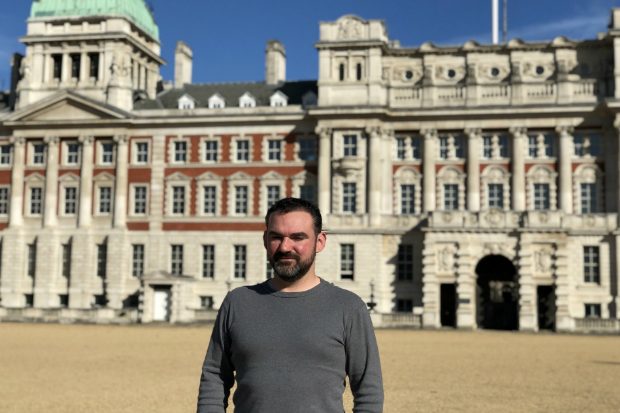 Sam standing in front of a building.