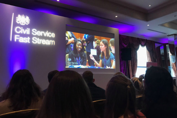 People watching a presentation on a big screen.