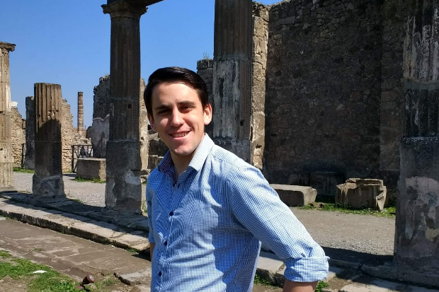 Adam standing in front of an ancient building